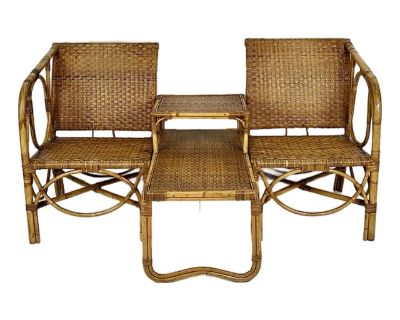 Vintage mid century rattan sectional side table and arm chairs set. Woven caning wrapped chairs with bent rattan details. Matching two tier side table in between, making a unique seating area. Perfect for an entry, or anywhere you need extra seating. Pieces are not attached and can be separated. Beautiful aged patina. Unmarked, but has the look of older French rattan. Measurements- Total- 60" L...
