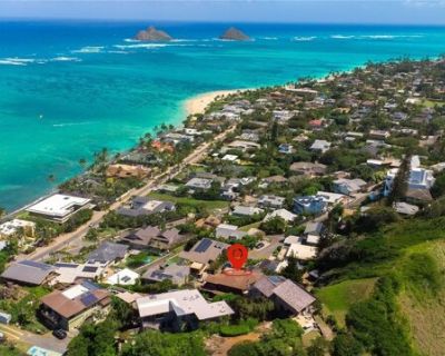 21 Aalapapa Pl. Experience breathtaking ocean and Mokulua Islands views from this exquisite Lanikai hillside residence. Comes fully furnished, including art, kitchenware, linens, beach gear, Completely rebuilt in 09 with elegant finishes: hardwood floors, custom woodwork, granite countertops, split ACs, and jacuzzi tub.. Lush tropical landscaping, serene waterfall, and a bridge lead to a deck a...