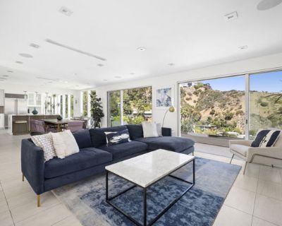 Hillside Avenue. Perched above the iconic Sunset Strip, this beautifully updated contemporary residence offers sweeping city and canyon views from every room. Designed to maximize natural light and indoor-outdoor flow, the open floor plan features expansive decks on every level, perfect for entertaining or unwinding in the California sun.The home includes two spacious primary suites, a guest be...