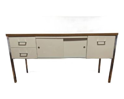 Motivated Seller! Make me an offer I can't pass up. Excellent Mid-Century Modern office credenza from the 1960s, in the style of Steelcase furniture. Constructed with a durable metal body, it includes two small drawers, one file drawer, and a center console with sliding doors. Finished with chrome accents and faux walnut laminate, it has a distinctive retro look. Overall in good condition with ...