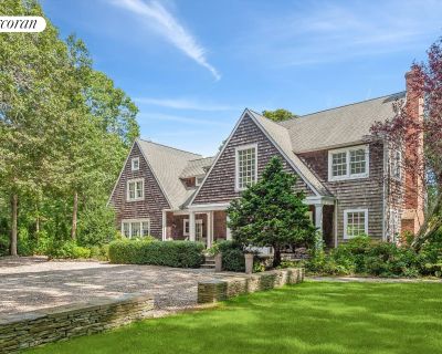 9 Laura's Lane. Discover tranquility in this East Hampton oasis, nestled on a private shy one-acre lot, with convenient access to Amagansett. This exquisite residence boasts five bedrooms, each equipped with large TVs, and a fully finished lower level designed for entertainment and relaxation. The lower level features a plush couch, bar area, and game space, complemented by an 80" high-definiti...