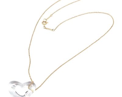 This Tiffany & Co. necklace by Elsa Peretti features a large rock crystal open heart pendant and is suspended from an 18k yellow gold chain. Details: Metal: 18k Yellow Gold Chain Length: 16.5" Pendant: 19mm x 23.5mm Weight: 4.3 grams Stones: Rock Crystal Hallmarks: Tiffany & Co 750 Elsa Peretti. Styles Contemporary Primary Stone Shape Heart Necklace Length 16.5 in Primary Stone Quartz Primary S...