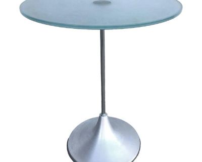 Y2K era side table featuring a floating frosted green glass top resting on a brushed aluminum base. The table echoes the sleek elegance of Charles Hollis Jones iconic Bugle design with a late 20th-century twist. Unsigned 5 Available Dimensions: 25" height x 19 3/4" diameter United States, 1999. Dimensions 19.75 W 19.75 D 25 H Styles Modern Table Shape Round Period 1990s Country of Origin United...