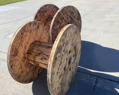 2 medium round wood spools that are burned look effect excellent shape used for graduation and weddings arrangements $400 or $250 for one