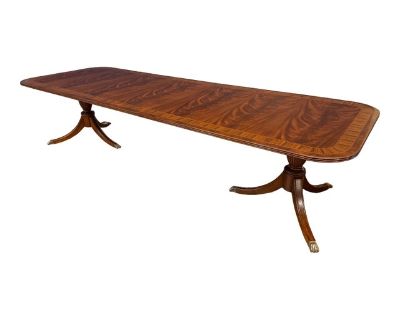 This is a Traditional Multi-Banded Mahogany Dining Table by Leighton Hall Furniture. It features a field of swirly crotch mahogany with two borders of Pau Ferro and crotch mahogany. It also has a solid mahogany three beaded edge. The top has a hand steel wool rubbed satin finish which allows the table to blended in well with existing antiques. The pedestals have fluted legs which terminate with...