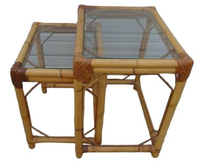 Bring a touch of island elegance to your home with this set of 2 vintage bamboo and rattan nesting end tables, inspired by Hollywood Regency and West Indies tropical design. Each table features a natural bamboo frame, woven rattan tops, and beautiful handcrafted detailing that highlights timeless coastal style. Perfect as side tables, plant stands, or accent pieces, they nest neatly together fo...