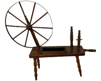 This 1970s vintage wooden spinning wheel by Home Interiors & Gifts was originally designed as a decorative piece. In a Colonial Revival-style accent the spinning wheel captures the rustic elegance of early Americana design popular in mid-century to late-century suburban homes. Crafted from what appears to be solid stained pine, the spinning wheel features classic spokes, a rotating wheel, and a...