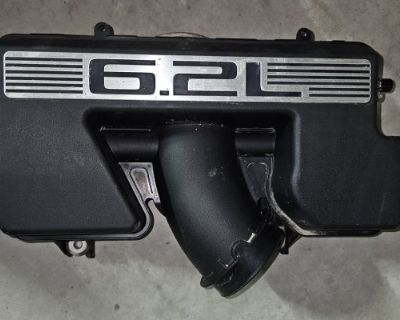 I'm looking for the factory intake silencer. It's the section that connects to the throttle body. Both air bungs on driver's side must be intact. Since a picture is worth a thousand words... here's what i'm looking for: