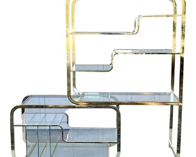 Stunning two-piece brass etagere by Design Institute of America. Inspired by Milo Baughman s designs this piece features sculpted lines, glass record storage, and modular design. The piece is in overall excellent vintage condition with some age appropriate patina and wear to brass plating. 71.75 H | 48 W | 18 D 46.5 W bottom, 48 W top. Dimensions 48 W 18 D 71.75 H Styles Art Deco Mid-Century Mo...