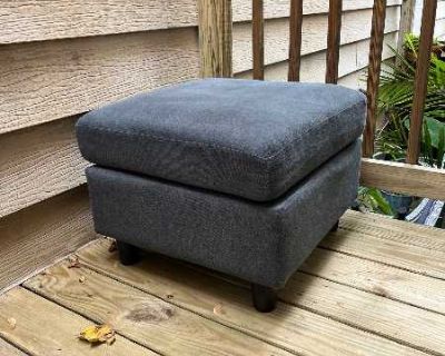 Blue fabric ottoman from no pet / no smoking home. 23" square, 17" high No storage, but it is light enough for one person to easily carry. Pick up Tues 10/28 before 6pm or Wed 10/29 between 9am-9pm.
