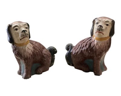 A Pair of Mid 20th Century British Colonial Seated Burgundy & White Dogs