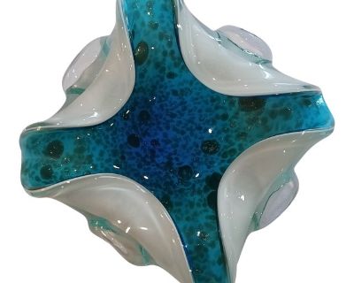 This striking mid-century Murano attributed hand-blown glass bowl features a sculptural free-form design with an undulating, wavy rim. The interior shimmers with vibrant turquoise hues speckled with aventurine sparkle, while the base is finished in lattimo white glass. Attributable to Barovier Toso Glass Works, the piece showcases traditional Murano techniques including Lattimo, Sommerso, and A...