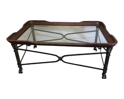 A vintage bronzed metal, Maitland Smith Regency cocktail table with leather trim, paw feet, and brass nail heads. Glass insert has rounded corners.. Dimensions 46 W 28 D 20 H Styles Regency Table Shape Rectangle Brand Maitland - Smith Period 2000 - 2009 Country of Origin United States Item Type Vintage, Antique or Pre-owned Shop Sustainably with Chairish Materials Glass Leather Metal Condition ...