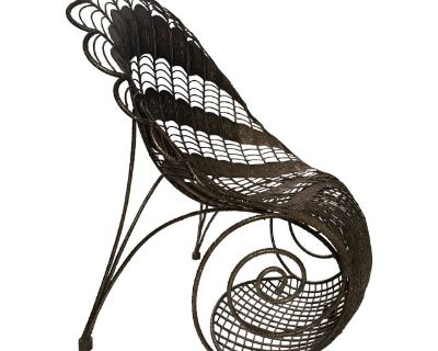 This Large Wrought Iron Chair with Peacock Design showcases a dramatic and ornate fan-shaped form that mimics a peacock's plumage in full display. The piece is constructed from delicately curved metal strips woven into a dramatic, openwork pattern, with decorative embossed panels adorning the chair's backing. The contoured seat is supported by a bold spiral scroll on either side, giving the pie...