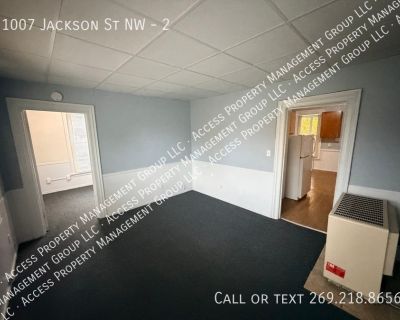1007 Jackson St NW. Apt 2 is an upper two bedroom one bathroom Unit. Once upstairs you have a spacious family room with lots of daylight. Two bedrooms with blinds and carpet. Full bathroom with large claw foot tub. Spacious kitchen with new cupboards and roof for a breakfast table. There is a large pantry as well. Shared laundry in the basement. On street parking. No pets. New residents would p...