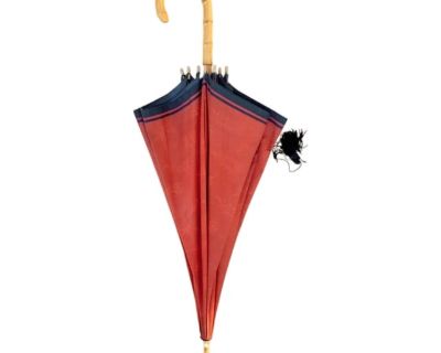 A lovely, vintage YSL tassel umbrella. Features a tone-on-tone red floral pattern accented with navy trim and adorned with a blue tassel. Accented with a bamboo handle and finial. Labeled Yves St Laurent to the interior tag.. Dimensions 40 W 40 D 35 H Styles Hollywood Regency Traditional Transitional Brand Yves Saint Laurent Period Late 20th Century Item Type Vintage, Antique or Pre-owned Shop ...