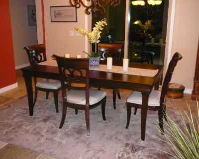 Dining Table with 4 chairs with white padded seats.