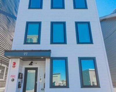 97 Condor St Apt 6. Built in 2022, this modern sixth-floor residence offers 999 sq ft of thoughtfully designed living space. The open-concept layout features two spacious bedrooms, 1.5 baths, hardwood floors, central A/C, and in-unit laundry. Enjoy your own private balcony and an exclusive roof deck with city and water views - perfect for relaxing or entertaining. The kitchen shines with stainl...