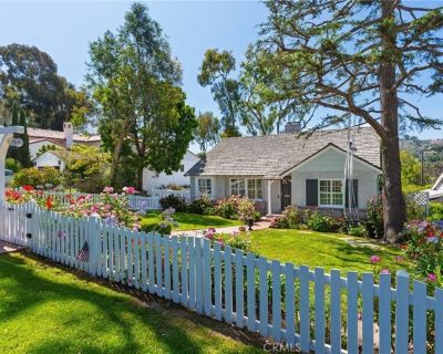 3220 Palos Verdes Dr N. This home comes complete with a white picket fence in the heart of Valmonte and blends timeless charm with modern amenities. A lush front yard and blooming roses welcome you into a warm interior featuring hardwood floors, custom shutters, and elegant moldings. The formal living and dining rooms are perfect for entertaining. The bright kitchen offers white cabinetry, gran...