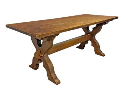 An early 20th-century Danish trestle table, circa 1900 1920s, crafted from thick solid oak planks and built with a clarity of purpose that feels distinctly Nordic. The table dismantles completely its top secured by wooden pegs, the stretcher held firm by hand-carved wedges slipped through the X-shaped legs revealing a joinery system that is as beautiful as it is practical. The design nods to ce...