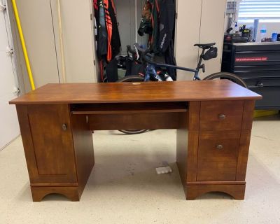 Brown desk and two barstools