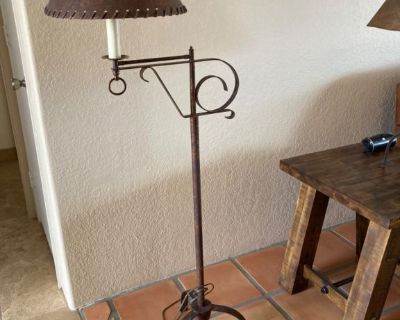 Metal floor lamp with copper overtones.  Shade is leather looking with leather bindings.