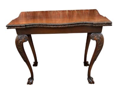 Georgian Mahogany Gaming Table. Finely Carved Legs depicting a Serpent and Ball and Claw Talons ,also Top has Drape and Floral Carved Edge. Top leaf swivels and flips exposing an antique velvet card playing surface. Made in England by a highly skilled Cabinetmaker . Gaming surface measures 36 x 36 inches. Dimensions 35 W 18 D 33 H Styles Georgian Table Shape Rectangle Period Mid 19th Century Co...