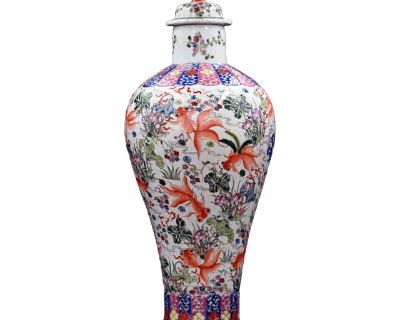 This large antique Chinese Famille Rose porcelain temple jar makes a radiant statement with its joyful goldfish motif and vibrant hand-painted floral design. Featuring swirling orange goldfish swimming among blooming lotuses and peonies, the composition embodies traditional Chinese symbolism of abundance, prosperity, and harmony all captured in luminous enamel overglaze. The vase is beautifully...
