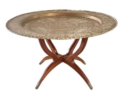 Graceful and functional, this vintage Mid-Century Chinoiserie brass tray table features a removable etched tray atop a folding spider-leg wood stand with four brass-capped feet. The tray top features a raised faux bamboo edge surrounding a central Chinese Fu character symbolizing "good fortune, blessings, and happiness", Chinese dragons, and other Chinoiserie motifs. The tray table is 31.5" in ...