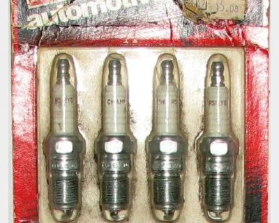 A set of 4 champion spark plugs still in original container number RS12YC