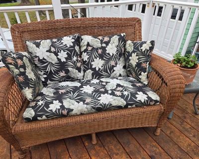 Wicker love seat with cushions